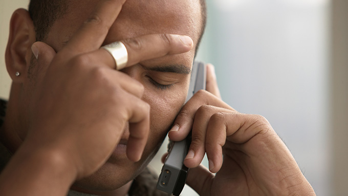 Homem Preocupado ao Telefone